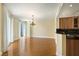 Bright and airy living room with hardwood floors, chandelier, and a partial view of the kitchen at 2857 Paradise Rd # 802, Las Vegas, NV 89109