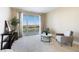 Bright living room featuring neutral carpet, seating area, and a sliding door to a private balcony at 2857 Paradise Rd # 802, Las Vegas, NV 89109