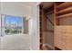 Well-organized walk-in closet with built-in shelving and drawers adjacent to a bedroom with views at 2857 Paradise Rd # 802, Las Vegas, NV 89109
