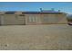 Rear exterior view of house featuring a gravel yard and solar panels on the roof at 2920 Malibou Ave, Pahrump, NV 89048