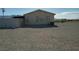 Exterior view of the home from the back showing gravel and mountain views at 2920 Malibou Ave, Pahrump, NV 89048