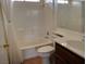 Bright bathroom featuring a shower-tub combination, white tile, and wood-look floors at 2920 Malibou Ave, Pahrump, NV 89048