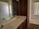 Bathroom vanity with double sinks, dark wood cabinetry and a built-in tub at 2920 Malibou Ave, Pahrump, NV 89048
