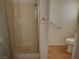 Bathroom featuring laminate floors, shower stall and white toilet at 2920 Malibou Ave, Pahrump, NV 89048