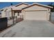 Single story home with two car garage, desert landscaping and chain link fence at 2920 Malibou Ave, Pahrump, NV 89048