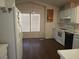 Open kitchen with dining area, vinyl floors and white appliances at 2920 Malibou Ave, Pahrump, NV 89048