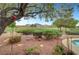Landscaped backyard featuring views of the community golf course, mature trees, and a relaxing pool area at 2929 Haddon Dr, Las Vegas, NV 89134