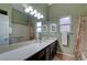 Bathroom with dual sinks, a large mirror, vanity lighting, and a shower-tub combination at 2929 Haddon Dr, Las Vegas, NV 89134