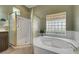 Bathroom with a walk-in shower, garden tub, and block window at 2929 Haddon Dr, Las Vegas, NV 89134
