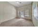 Spacious bedroom features a ceiling fan, neutral walls, carpet flooring, and a patio door overlooking the pool at 2929 Haddon Dr, Las Vegas, NV 89134