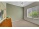 Spacious bedroom with a ceiling fan, carpeted floors, and large window offering ample natural light at 2929 Haddon Dr, Las Vegas, NV 89134