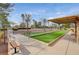 Outdoor bocce ball court with seating surrounded by trees and landscaping at 2929 Haddon Dr, Las Vegas, NV 89134