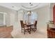 Bright dining room with tray ceiling and chandelier over a wood dining table at 2929 Haddon Dr, Las Vegas, NV 89134
