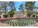 Sun City Summerlin community entrance, featuring lush landscaping, a manicured garden, and mature trees at 2929 Haddon Dr, Las Vegas, NV 89134