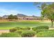 Beautiful view of the golf course homes, lush green fairway, and mountain backdrop on a clear day at 2929 Haddon Dr, Las Vegas, NV 89134