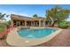 Beautiful backyard pool and spa combination with an adjacent patio, surrounded by desert landscaping and mature trees at 2929 Haddon Dr, Las Vegas, NV 89134