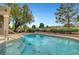 Relaxing backyard pool and spa area featuring desert landscaping, lush trees, and serene golf course views at 2929 Haddon Dr, Las Vegas, NV 89134