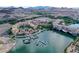 Scenic aerial view of community featuring waterfront properties, a lake, pool, and desert mountain backdrop at 30 Strada Di Villaggio # 306, Henderson, NV 89011