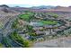 Expansive aerial view of a luxury community with golf courses, a serene lake, and stunning mountain backdrops at 30 Strada Di Villaggio # 306, Henderson, NV 89011