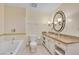 Well-lit bathroom with granite countertops, oval mirror, and tiled shower-tub combo at 30 Strada Di Villaggio # 306, Henderson, NV 89011