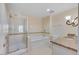 Well-maintained bathroom with a shower, separate tub, granite countertop, and tiled walls at 30 Strada Di Villaggio # 306, Henderson, NV 89011