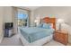 Cozy bedroom featuring a large window, comfortable queen bed, and stylish furnishings at 30 Strada Di Villaggio # 306, Henderson, NV 89011