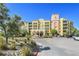 Beautiful condo complex with arched entry, water feature, mature landscaping, and ample parking at 30 Strada Di Villaggio # 306, Henderson, NV 89011
