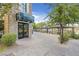 Inviting entrance to Seasons Grocery, stone facade with modern glass doors opening onto a lush walkway at 30 Strada Di Villaggio # 306, Henderson, NV 89011