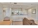Cozy kitchen open to the living space, featuring counter seating and standard appliances at 30 Strada Di Villaggio # 306, Henderson, NV 89011