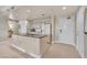 Bright kitchen featuring a granite counter, white cabinets, and standard appliances at 30 Strada Di Villaggio # 306, Henderson, NV 89011