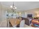 Comfortable living room with dining area that opens to a functional kitchen and features neutral tones throughout at 30 Strada Di Villaggio # 306, Henderson, NV 89011