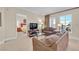 Comfortable living room with a view to the bedroom, featuring soft seating, tv and natural light at 30 Strada Di Villaggio # 306, Henderson, NV 89011