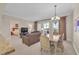 Comfortable living area leading to a dining space and featuring natural light and neutral tones at 30 Strada Di Villaggio # 306, Henderson, NV 89011