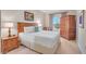 Cozy main bedroom featuring a comfortable bed, and wooden furniture with natural light at 30 Strada Di Villaggio # 306, Henderson, NV 89011