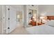 Inviting main bedroom featuring a comfortable bed, mirrored closet, and a glimpse into the ensuite bathroom at 30 Strada Di Villaggio # 306, Henderson, NV 89011