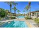 Beautiful community pool and hot tub area with landscaped design and covered lounge areas on a clear day at 30 Strada Di Villaggio # 306, Henderson, NV 89011