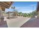 Wide view of the backyard which features desert landscaping, pea gravel, and a covered pergola with built-in benches at 3101 Greenbriar Dr, Las Vegas, NV 89121