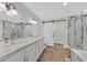 Bright bathroom featuring a soaking tub, separate glass shower, and a double vanity with granite countertops at 3101 Greenbriar Dr, Las Vegas, NV 89121