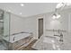 Bright bathroom featuring a soaking tub, separate glass shower, and a double vanity with granite countertops at 3101 Greenbriar Dr, Las Vegas, NV 89121
