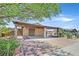 View of the covered carport showing a private gated area with desert landscaping at 3101 Greenbriar Dr, Las Vegas, NV 89121