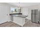 Bright kitchen features gray cabinets, stainless steel appliances, and a peninsula with a gray countertop at 3101 Greenbriar Dr, Las Vegas, NV 89121