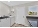 Functional laundry room with new washer and dryer, counter space, and a door at 3101 Greenbriar Dr, Las Vegas, NV 89121