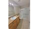 Bathroom featuring a shower with a sliding door and a vanity with tan countertops at 3151 Soaring Gulls Dr # 2101, Las Vegas, NV 89128