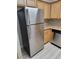 Spacious kitchen features modern stainless-steel refrigerator and ample maple cabinetry offering lots of storage at 3151 Soaring Gulls Dr # 2101, Las Vegas, NV 89128