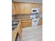 Functional kitchen featuring granite countertops, stainless steel sink, white appliances and ample counterspace for culinary endeavors at 3151 Soaring Gulls Dr # 2101, Las Vegas, NV 89128
