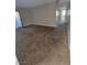 Carpeted living room featuring neutral tones and a sliding glass door at 3151 Soaring Gulls Dr # 2101, Las Vegas, NV 89128