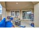 Covered outdoor patio with comfortable blue seating and a small fire pit, creating an inviting outdoor space at 3237 Mist Effect Ave, Henderson, NV 89044