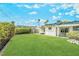 Expansive backyard featuring lush lawn, mature landscaping, and a covered patio area at 343 W Basic Rd, Henderson, NV 89015