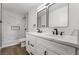Modern bathroom with marble tile, double vanity, and black fixtures at 343 W Basic Rd, Henderson, NV 89015