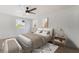 Bright bedroom featuring modern decor, a ceiling fan, and natural light from two windows at 343 W Basic Rd, Henderson, NV 89015